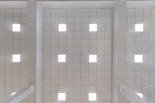 cassette stretched or suspended ceiling with square halogen spots lamps and drywall construction in empty room in house or office. Looking up view photo
