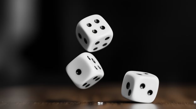 Three white dice rolling through the air above a wooden surface, captured in motion during a lively gaming session photo