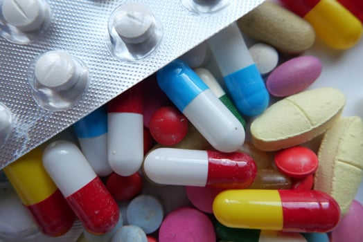 An Array of Colorful Pills and Capsules Arranged Neatly on a Bright White Surface photo
