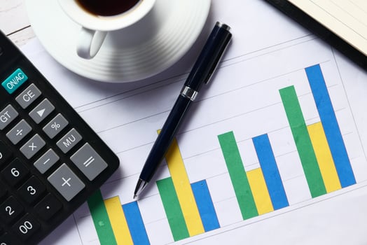 Business Analytics and Financial Growth Chart accompanied by a Cup of Coffee on Desk photo