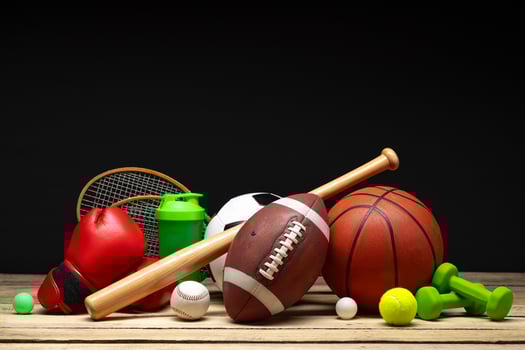 Various sports equipment on black background studio shot photo