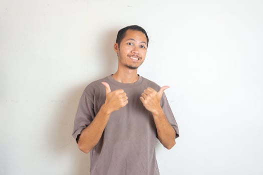 Young men wearing purple shirt smiling with thumbs up on isolated white background photo