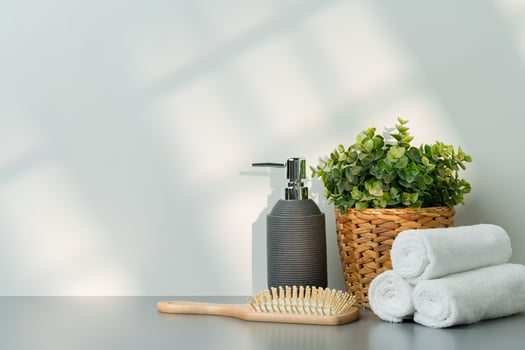 Soap dispenser and spa towels on white background in shadow photo