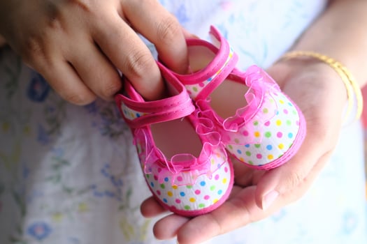 Adorable and charming Pink Polka Dot Baby Shoes, held with utmost care and love for little feet photo