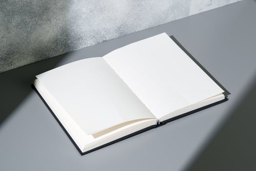 Blank open notepad on gray background studio shot photo