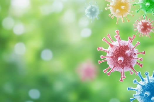 Colorful pathogens floating in the air against a blurred backdrop of vibrant outdoor greenery photo