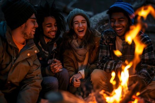 Four friends sitting around a campfire photo