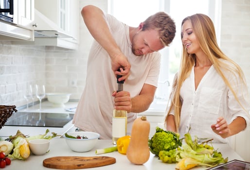 Young couple starting to drink a white wine at home photo