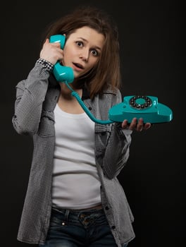 Portrait of the funny girl with old phone photo
