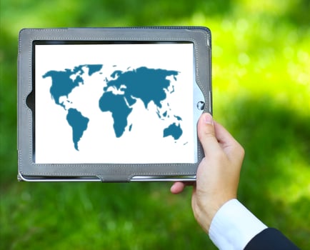 Man holding tablet computer with world map photo