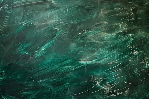 A green chalkboard with white writing and green paint photo