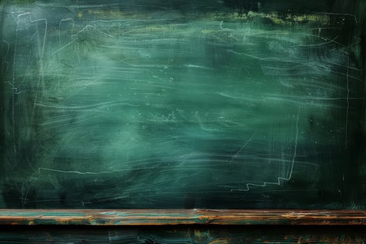 A green chalkboard with a wooden table in front of it photo
