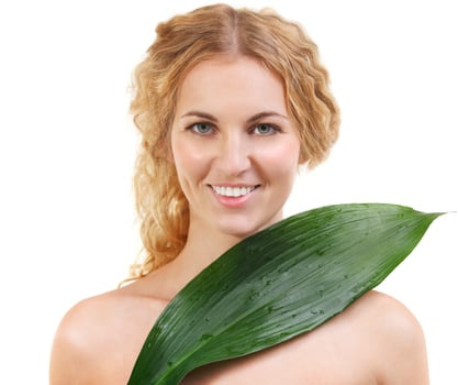 Portrait of the beauty young blond woman with green leaf photo