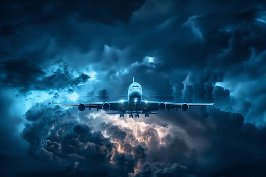 An airplane flying through the clouds at night photo
