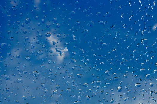 A blue sky with clouds and rain drops photo