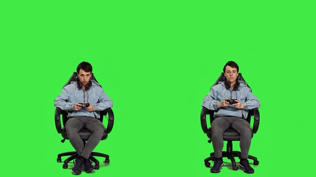 Excited proud player winning at games online tournament, sitting in a gaming chair against greenscreen backdrop. Woman gamer feeling happy after her e sport competition success. Camera A. photo