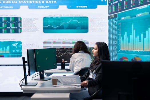 Business analyst reviewing performance indicators in office space, looking at a pc display with isolated copy space. Woman working on enterprise global expansion plans. Teamwork. photo