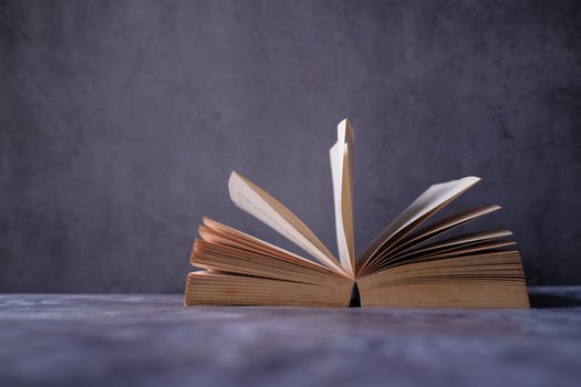 An Open Book Resting with Its Pages Displayed Against a Clean Minimalist Background photo