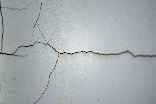 Close-Up of Cracked White Concrete Wall Texture for Background or Construction and Architecture Concepts photo