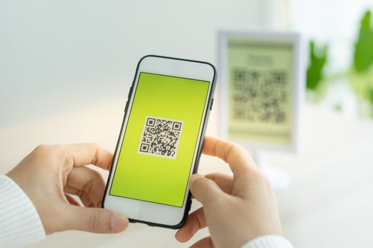 Woman use smartphone to scan QR code for order menu in cafe restaurant with a digital delivery. Choose menu and order accumulate discount. E wallet, technology, pay online, credit card, bank app photo