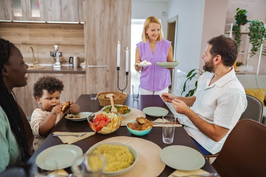 Family gathering around the table for a joyful meal together photo