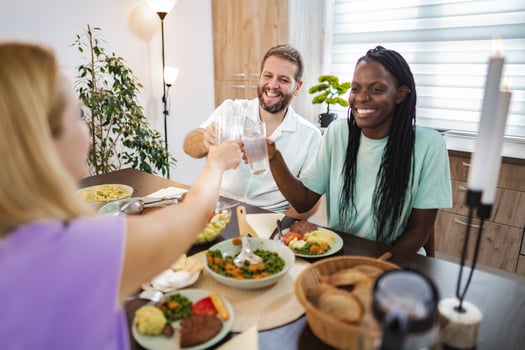 Friends gather for a joyful dinner celebration at home photo