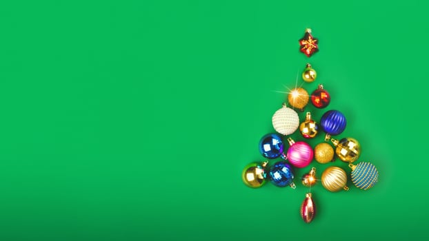 The Christmas tree is made of Christmas balls decoration. Minimum New Year concept. Card poster banner copy space green background photo