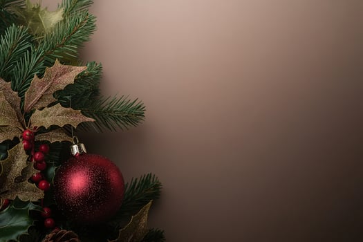 A collection of vibrant Christmas tree ornaments is carefully placed among lush evergreen branches and holly leaves, creating a festive atmosphere perfect for the holiday season. photo