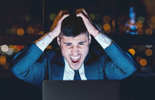 Business Failure. Emotional Businessman Shouting At Laptop Touching Head Working Overnight In Modern Office. Low Light photo