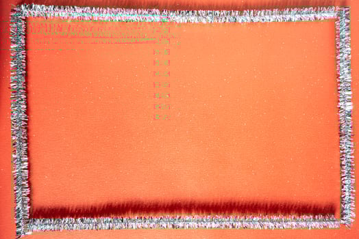 A red background for Christmas. With a frame made of zilver tree decoration. Christmas background. photo