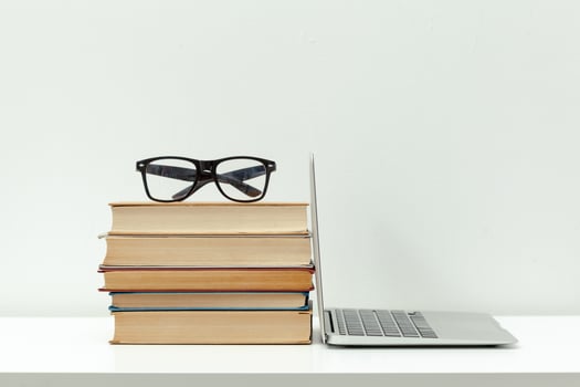 Working desk.Open laptop, books and other office supply photo