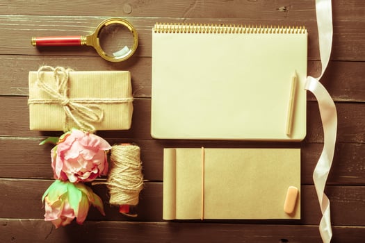 flowers and a notebook on wooden background photo