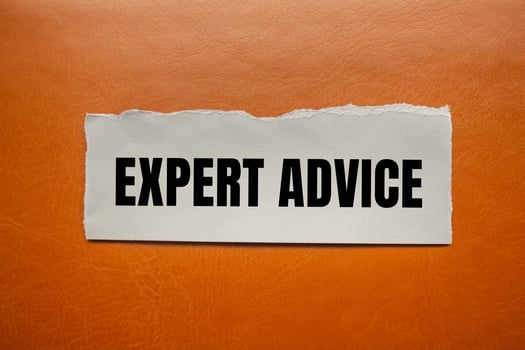 Expert advice message written on ripped torn paper piece with brown background. Conceptual expert advice symbol. Copy space. photo