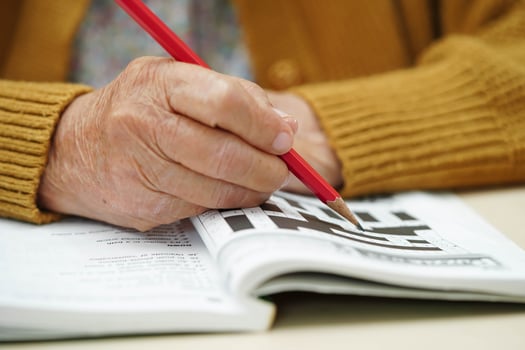Asian elderly woman playing puzzle game. photo