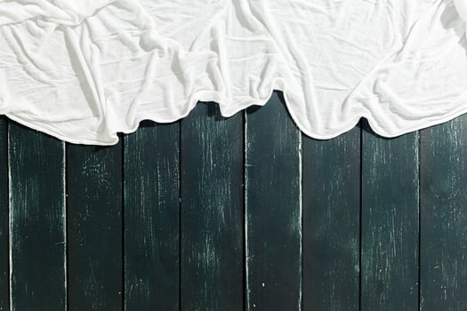White scarf over black wood table background photo