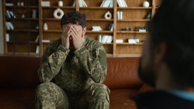 Worried depressed frustrated Caucasian sad despair patient man male client guy military combat uniform army soldier officer holding head pain talking to psychologist war stress crisis office therapy photo