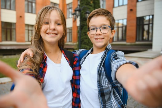 Portrait of smiling school kids standing at school yard photo