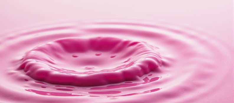 A pink circular water splash is displayed in an isolated setting photo