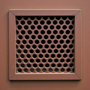 Rusty metal panel with rectangular vent circular hole pattern photo