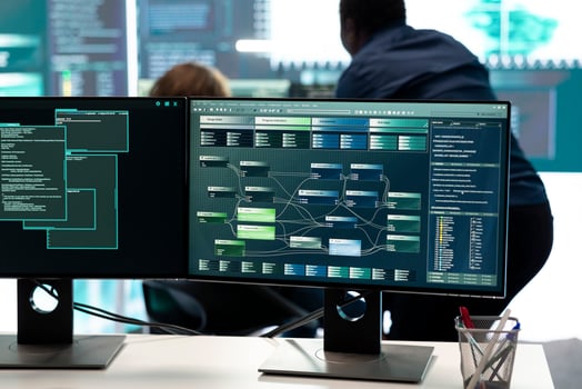 Cyber defense specialist examining information on a big screen in governmental center, focusing on cyber security operations and digital threats. Hacker ensures protection against cybercriminals. photo