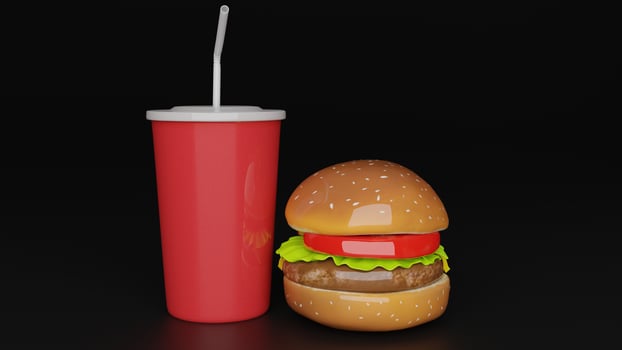 a hamburger and a red drink next to each other photo
