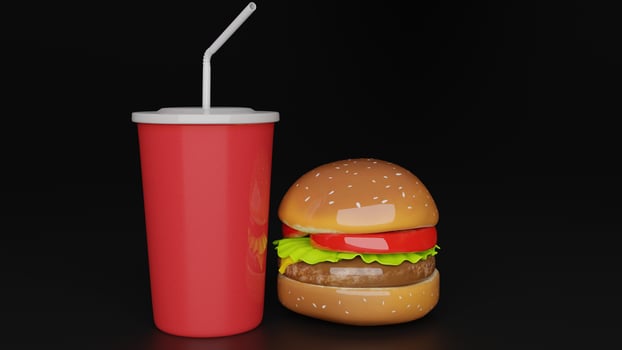 a hamburger with a drink and straw sitting on top of it photo