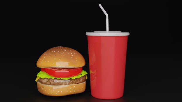 a hamburger with a drink and straw sitting on top of it photo