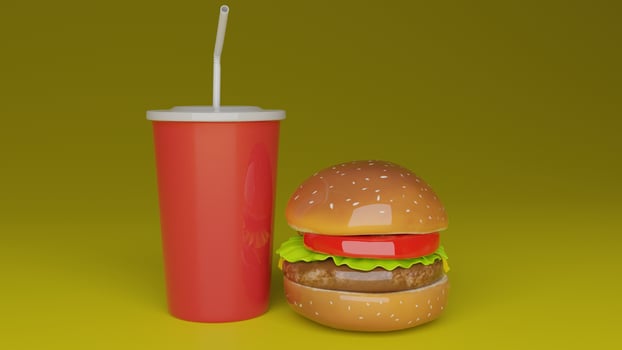 a hamburger with a drink and straw sitting on top of it photo