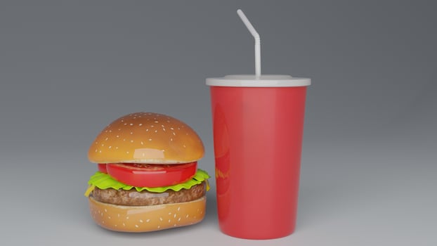 a hamburger with a drink and straw sitting on top of it photo