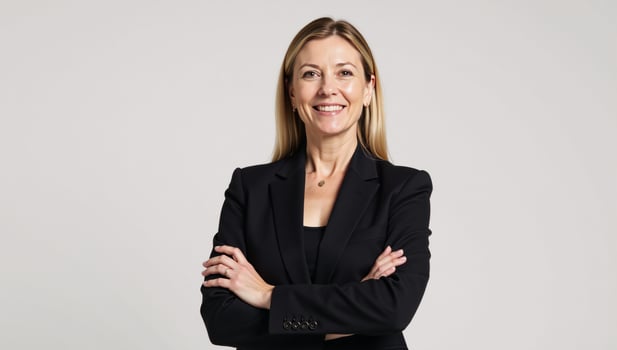 A professional confident businesswoman stands solo on a pristine white backdrop clad in black attire and striking pose photo
