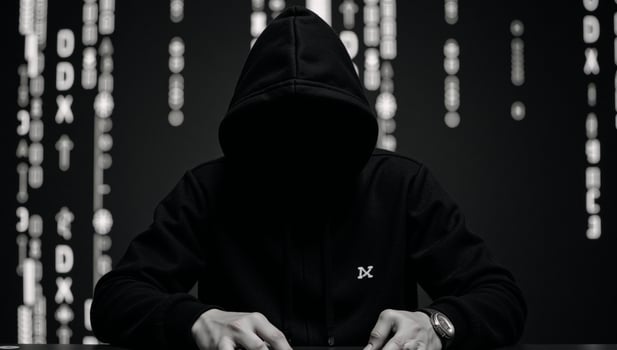 Image portrays a Matrixinspired hackers silhouette wearing a hoodie with distinctive patterns photo