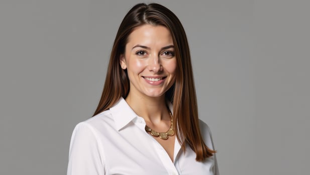 Businesswoman donning gold necklace and white shirt photo
