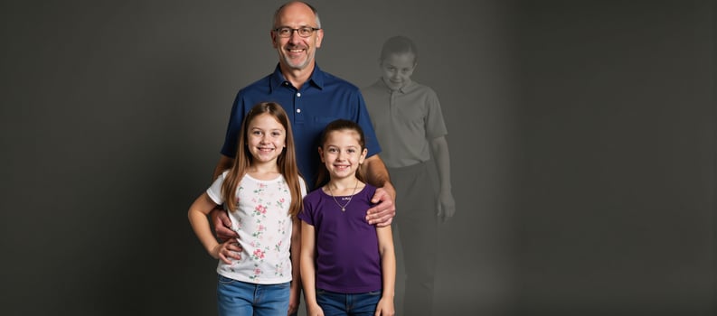 Children and their father gather with a translucent grandfather and the silhouettes of deceased relatives in a poignant depiction of familial connection photo
