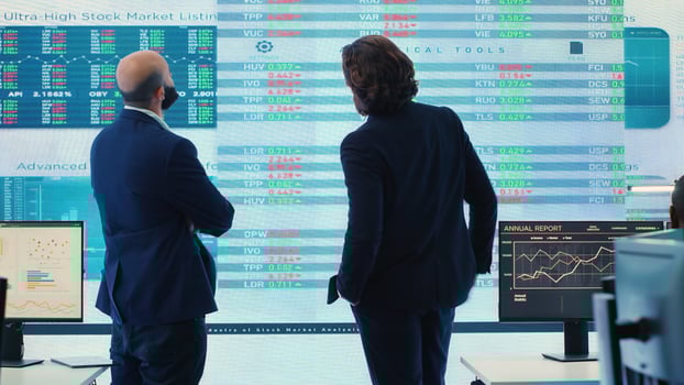 Business partners reviewing latest budgeting plans a big screen, sharing ideas and updates to ensure organizational progress. Forecast affiliates making decisions for a new fruitful project. Camera A. photo